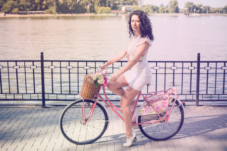 Beautiful Girl on a pink vintage Bike.の写真素材