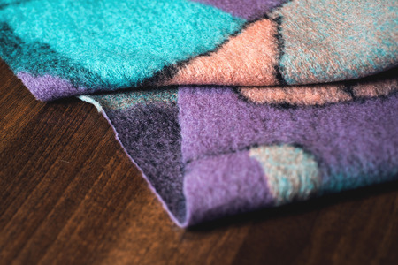 textured fabric on wooden background.の写真素材