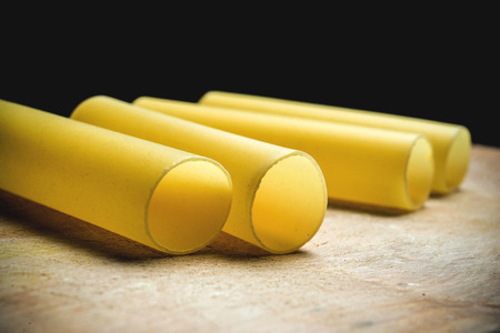 Raw cannelloni on an old wooden board close-upの写真素材