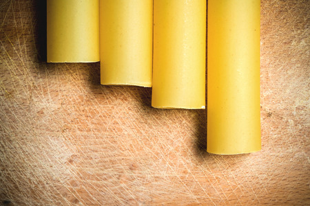 Raw cannelloni on an old wooden board close-upの写真素材