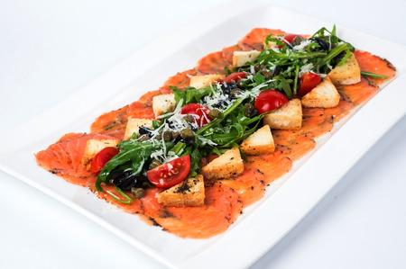 Appetizer - Salmon Carpaccio with Parmesan Cheese and Rucola.の写真素材