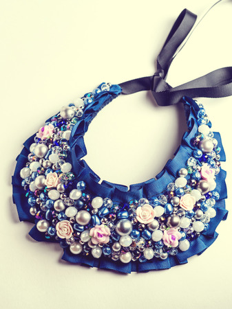 Handmade necklace with different jewels on white background. Not isolated. Vintage.の写真素材