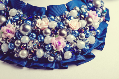 Handmade necklace with different jewels on white background. Not isolated. Vintage.の写真素材