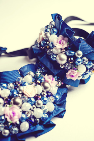 Handmade bracelet and necklace with different jewels on white background. Not isolated. Vintage..の写真素材