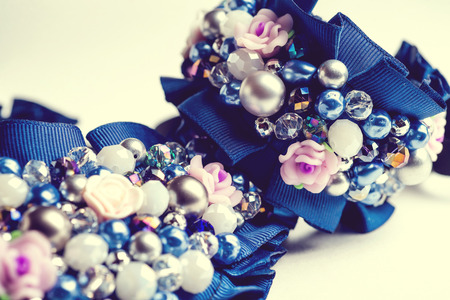 Handmade bracelet and necklace with different jewels on white background. Not isolated. Vintage..の写真素材