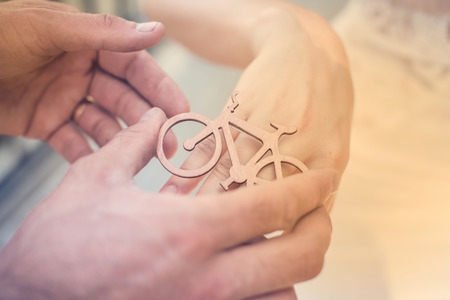 Decorative wooden bicycle ring  on a girls hand.の写真素材