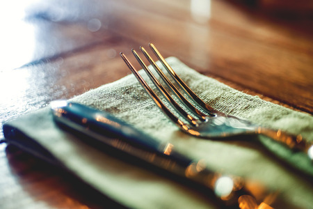 Knife and fork set on a wooden vintage table. Selective Focus.の写真素材