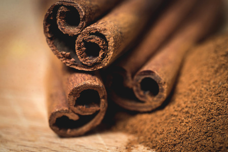 Cinnamon sticks with cinnamon powder on wooden background,の写真素材