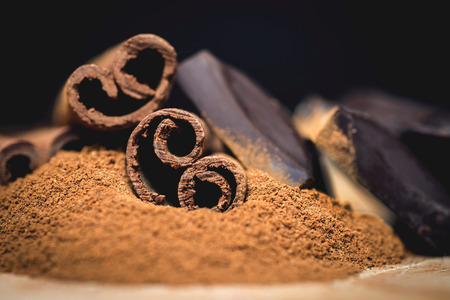 Cinnamon sticks with chocolate on vintage wooden backgroundの写真素材
