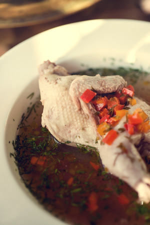 picture of traditional chicken soup served in a bowl over wooden background. Decorated.の写真素材