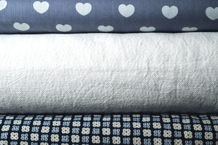 Rolls of colorful fabric as a vibrant background image.