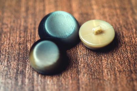 vintage buttons on wooden background.の写真素材