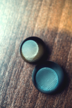 vintage buttons on wooden background.