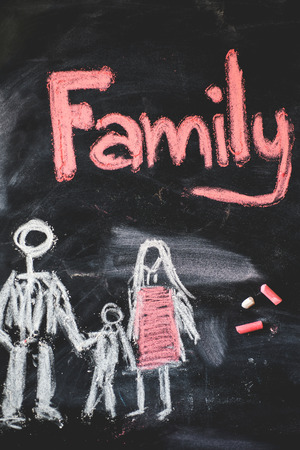 family handwritten with white chalk on a blackboardの写真素材