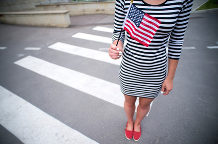 woman hand holding american flag.の写真素材