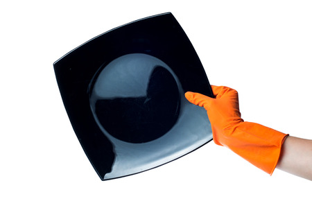 Hand in rubber glove with a plate on a white backgroundの写真素材