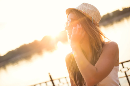 A portrait of a smiling beautiful woman talking on the phone.の写真素材