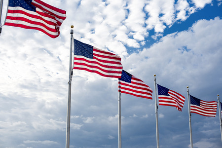 American flags winding on the blue sky.