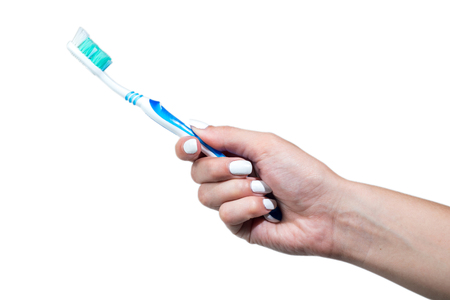 hand holding toothbrush isolated on white background.の写真素材