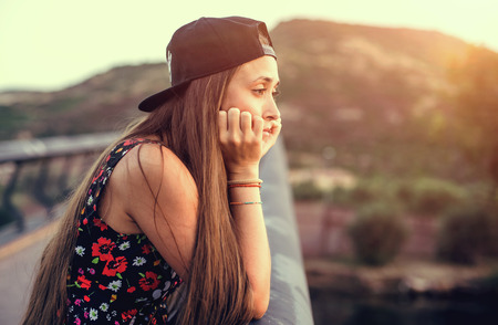 Young pretty woman in black dress, at sunset. Sardinia. Italyの写真素材