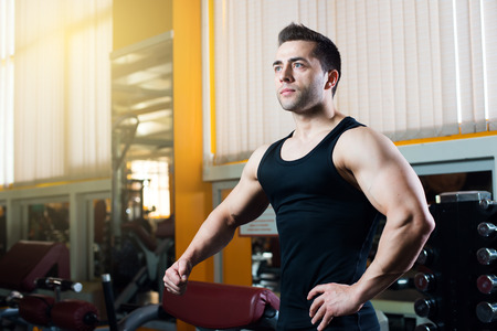 Strong Athletic Man showing muscles in gym.の写真素材