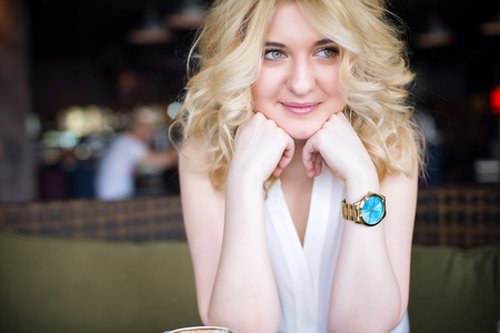 A young attractive business woman sitting in a cafe.の写真素材