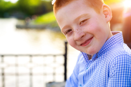 Stylish baby boy with ginger hair in trendy sunglasses.の写真素材