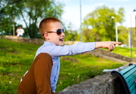 Stylish baby boy with ginger hair in trendy sunglasses.の写真素材