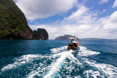 Traditional boat in a picture perfect tropical bay on Koh Phi Phi Island, Thailand, Asiaの写真素材