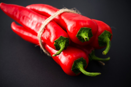 Red Chili peppers on a black background.の写真素材