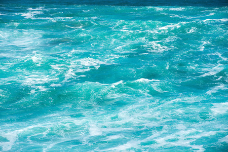 Blue Fresh Water Whitecap Waves Wash Ashore onto a Sandy Beachの写真素材
