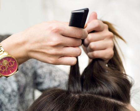 Hairdresser doing haircut for women in hairdressing salonの写真素材