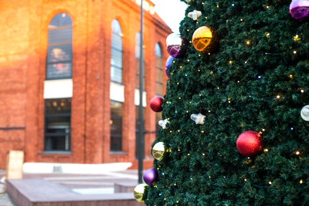 part of large outdoor Christmas tree in snow and ornamentsの写真素材