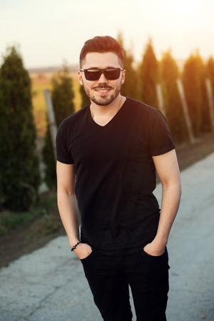 Young handsome man in sunglasses on the sunset.の写真素材
