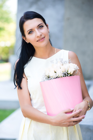 young girl with bouquet of roses in the basket.の写真素材