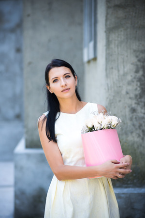 young girl with bouquet of roses in the basket.の写真素材