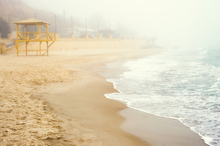 Sand beach in winter time. Foggy morning.の写真素材