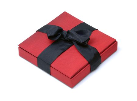 Red Silk Box with a Black Ribbon Bow on an Isolated Backgroundの写真素材