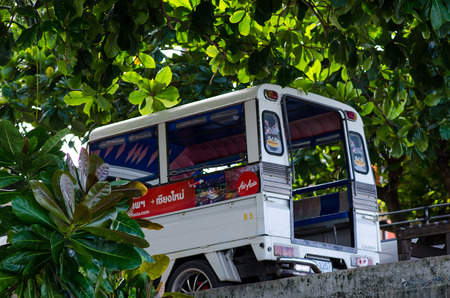 Krabi,Thailand-2016-A white tuktuk car parked under the trees.のeditorial素材