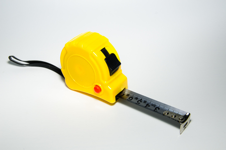 A yellow steel tape on white backgroundの写真素材