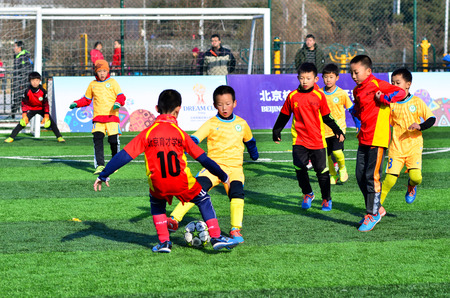 Beijing,China-December 2016-Students playing football in AOSHINE  football filed,Beijing of china.のeditorial素材