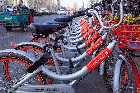 Beijing,China-February 2017-one row yellow bicycles called mobike shareing bicycle beside the street...