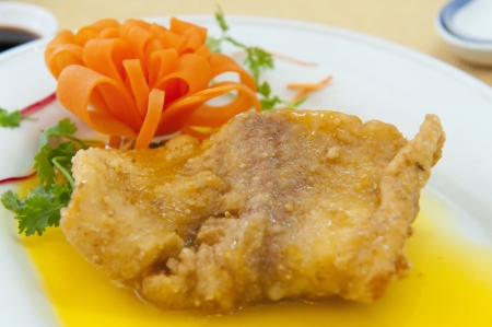 Fish dish at La Taverne prepared with sauce and carrot garnish in Ho Chi Minh Cityの写真素材