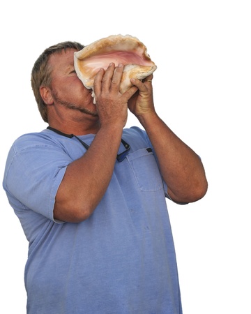 man blowing conch shell in Cat Island Bahamas