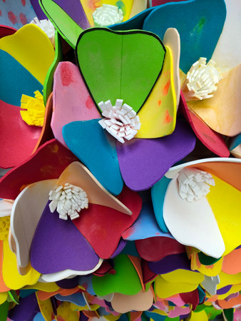 Colorful origami paper flowers as a background, closeup of photoの写真素材