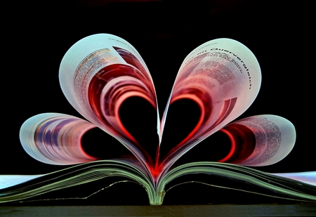 pages of a book curved into a heart shapeの写真素材