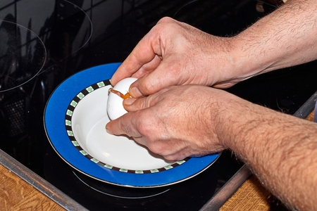 Separate eggs, season and whisk with a forkの写真素材