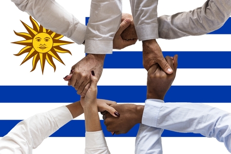 uruguay flag, intergration of a multicultural group of young people.の写真素材