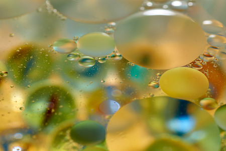 floating in the water abstract colorful, yellow oil dropsの写真素材