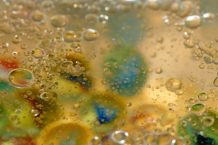 floating in the water abstract colorful, yellow oil dropsの写真素材